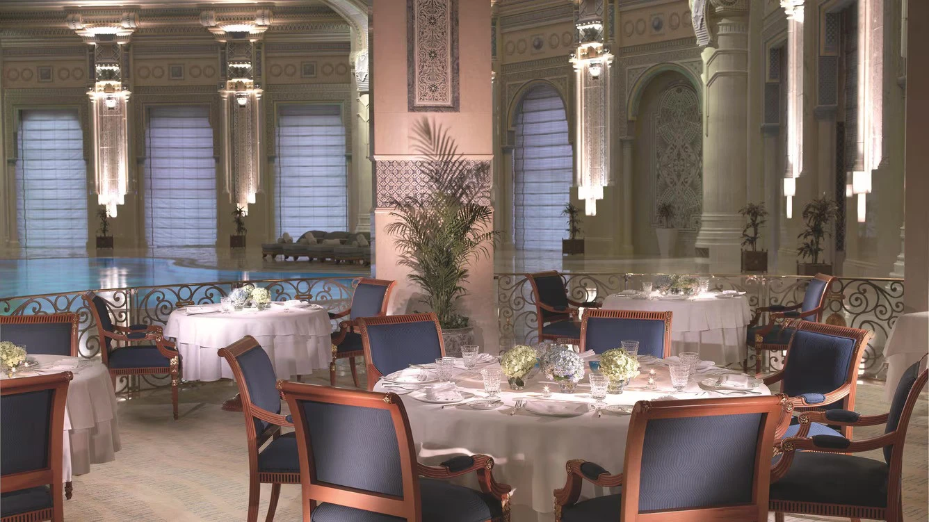 Elegant dining area at The Ritz Carlton Riyadh with pool view.