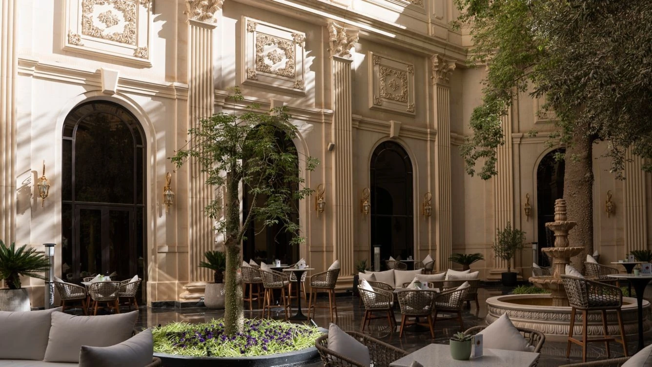 Elegant terrace at The Ritz Carlton Riyadh with seating and greenery.