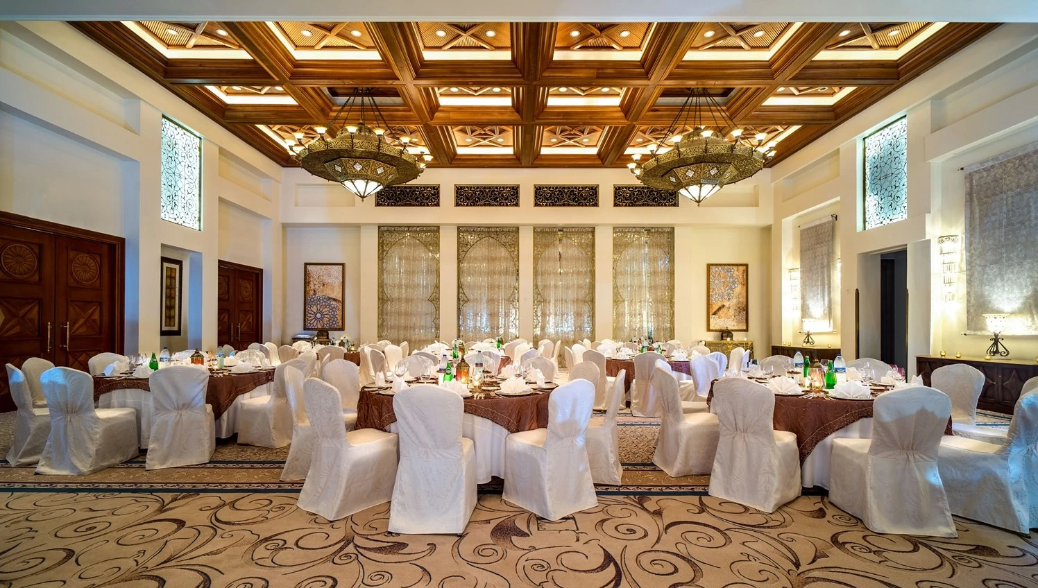 Elegant ballroom at One&Only Royal Mirage, Dubai, with ornate chandeliers.