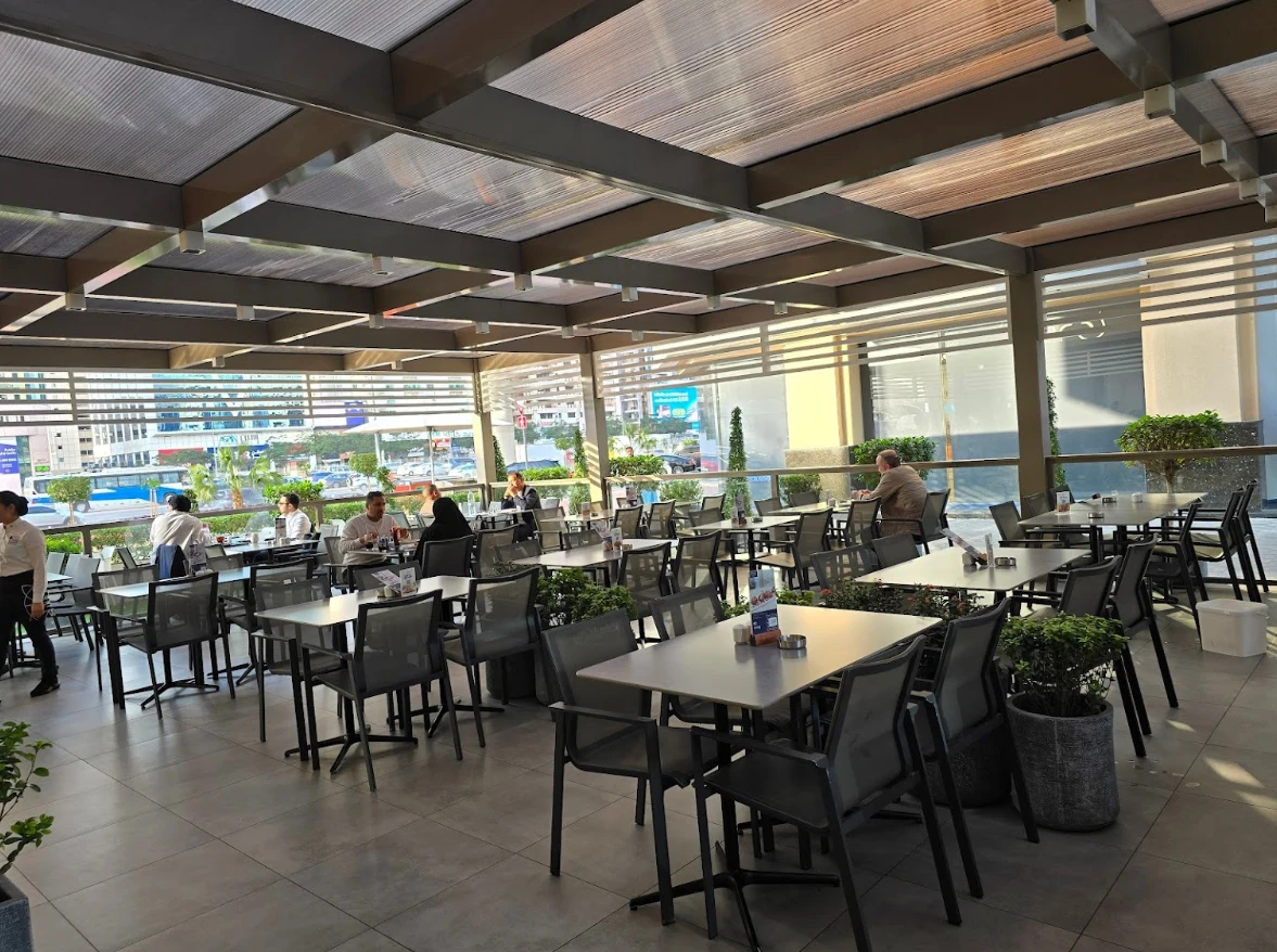 Outdoor seating at Al Safadi Restaurant DIFC, Dubai, with city view.