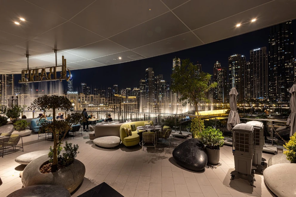 Babel Dubai Restaurant Downtown terrace with city skyline at night.