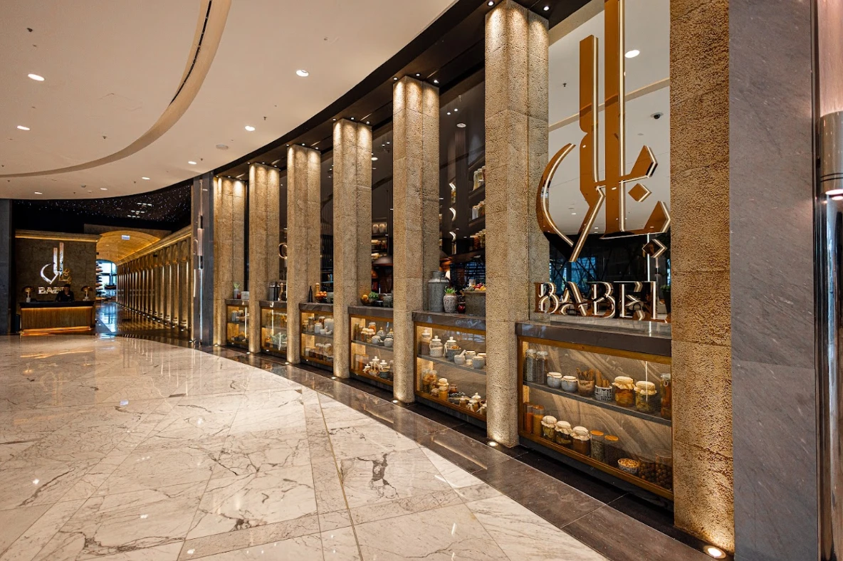 Elegant entrance of Babel Dubai Restaurant Downtown with decorative columns.
