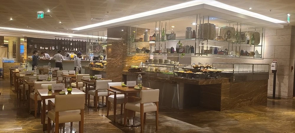 Modern dining area at Kitchen 6 Restaurant, Dubai, with buffet setup.