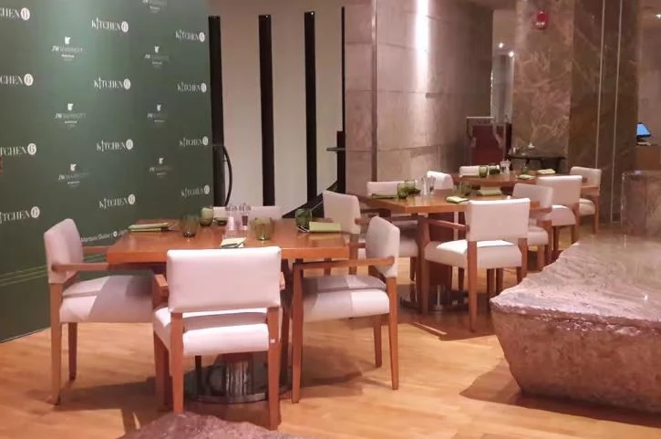 Stylish dining setup at Kitchen 6, Dubai with wooden tables.