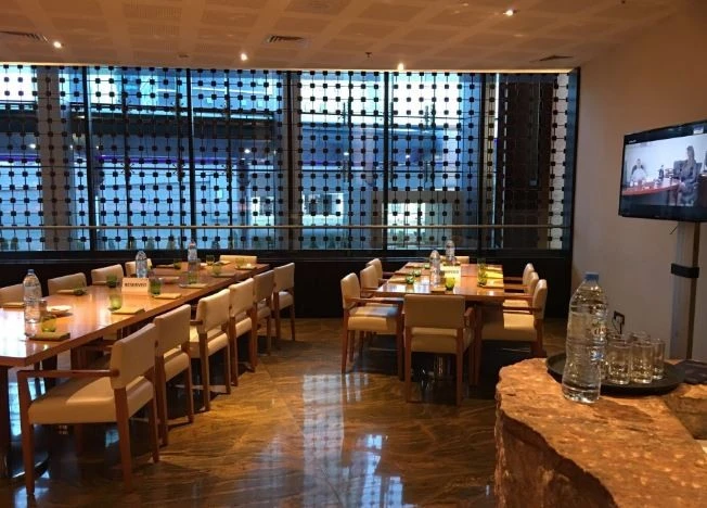 Elegant dining area at Kitchen 6 Restaurant, Dubai with large windows.