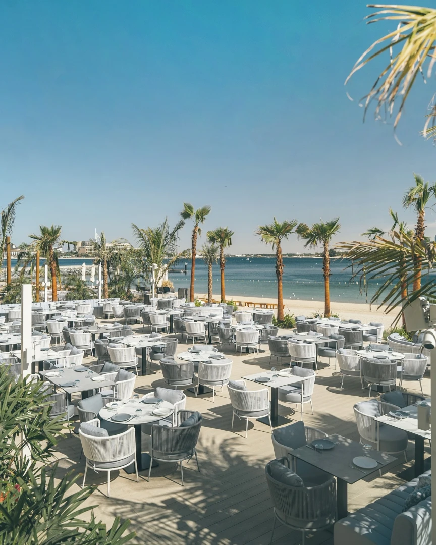 Outdoor dining area at Bebabel The Palm Restaurant, Dubai beachfront.
