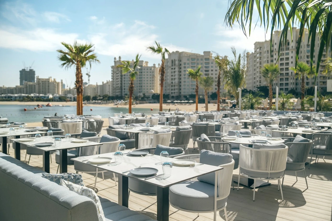 Outdoor dining at Bebabel The Palm Restaurant, Dubai beachfront view.