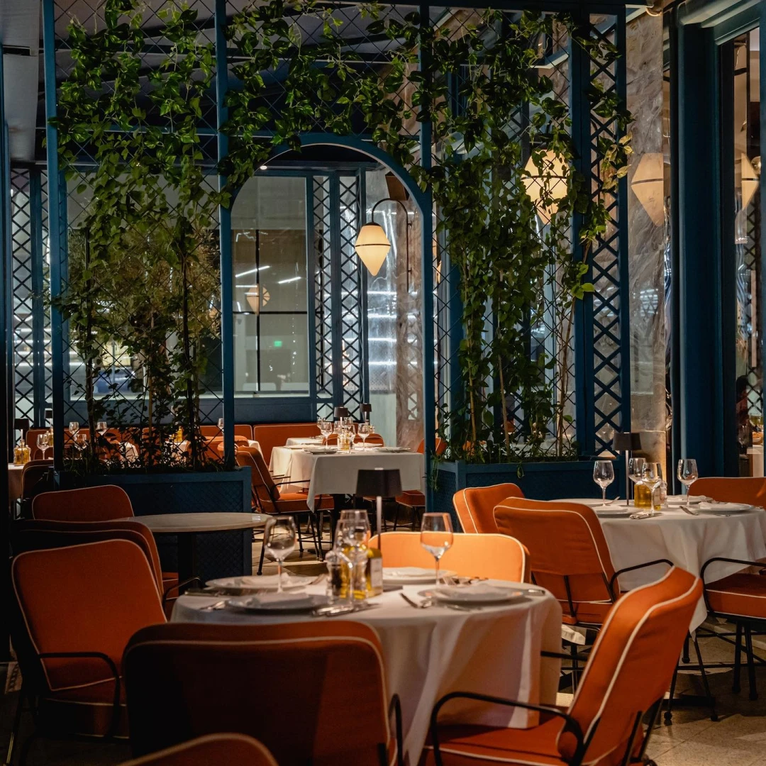 Elegant dining area at Il Baretto Restaurant Riyadh with greenery.