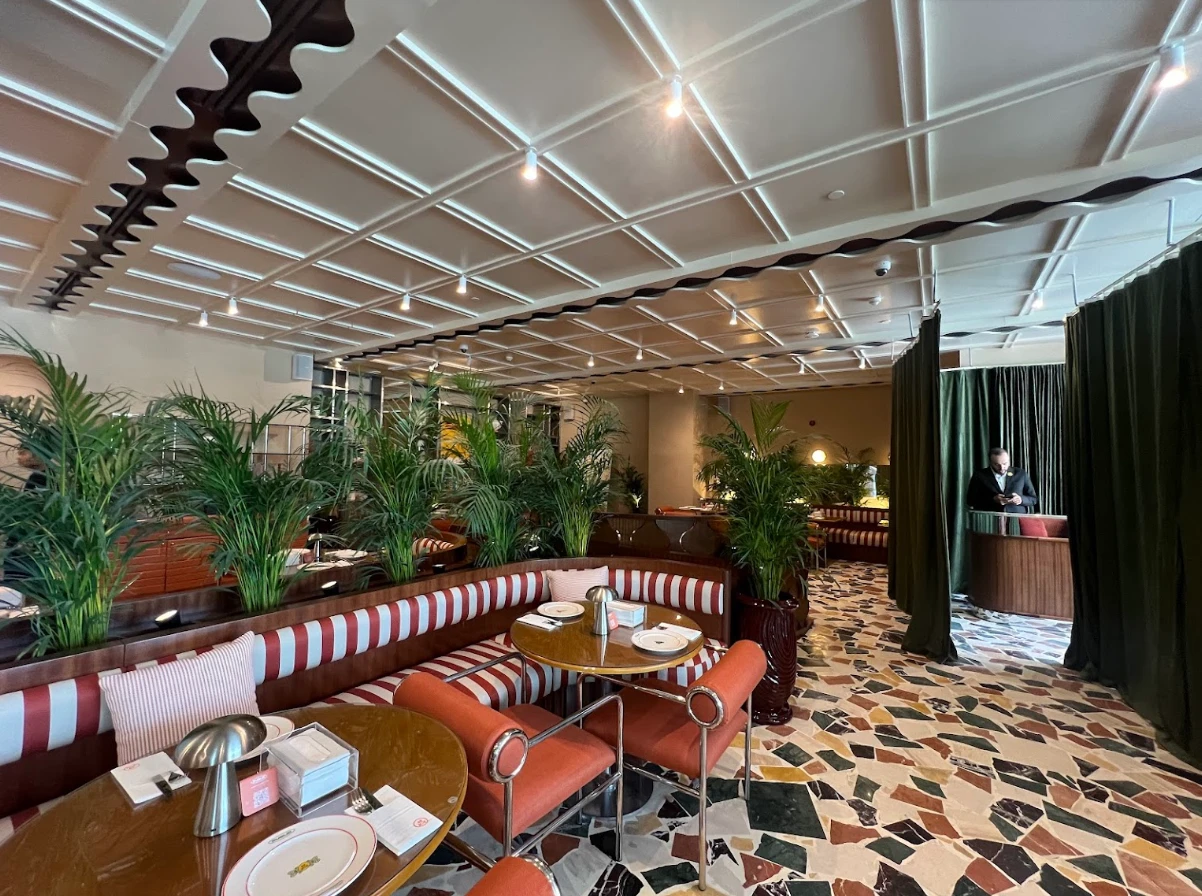 Stylish interior of PUBLIC Restaurant Riyadh As Sulimaniyah with plants.