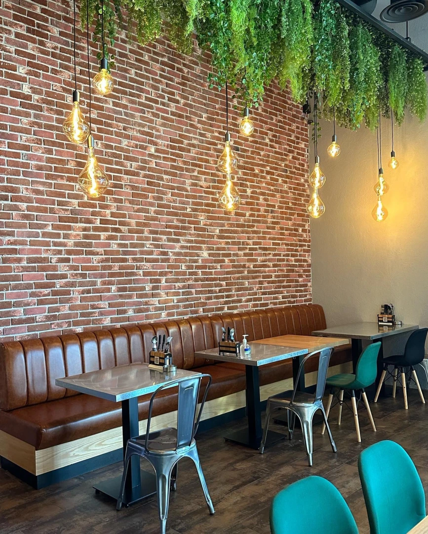 Swiss Butter Le Mall Jeddah, cozy seating with hanging lights and greenery.