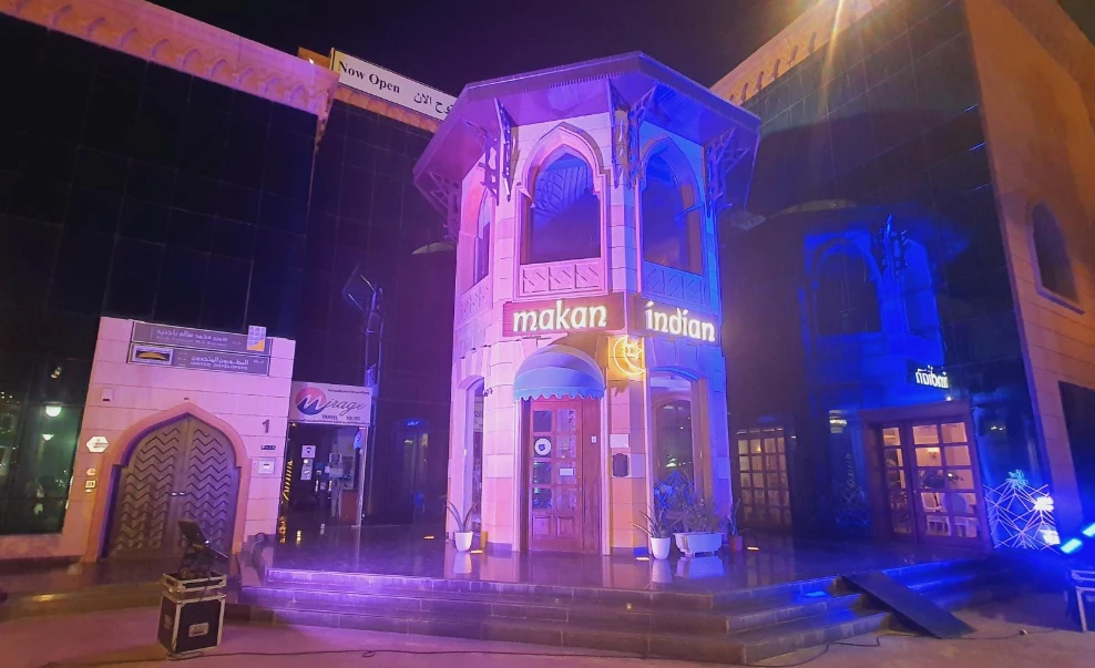 Makan Indian Restaurant Jeddah entrance illuminated at night.