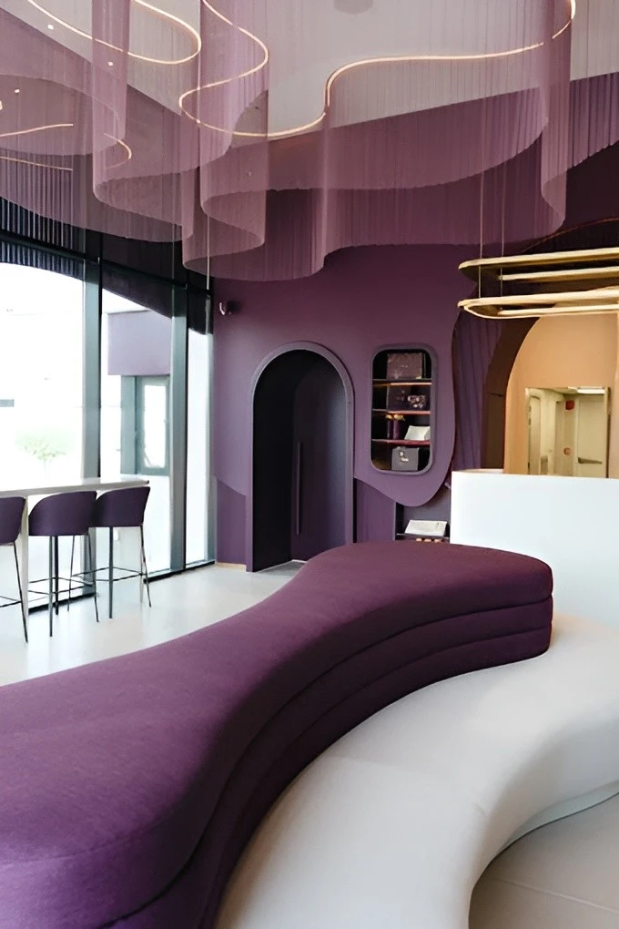Modern interior of Myra Cafe Jeddah with purple seating and decor.