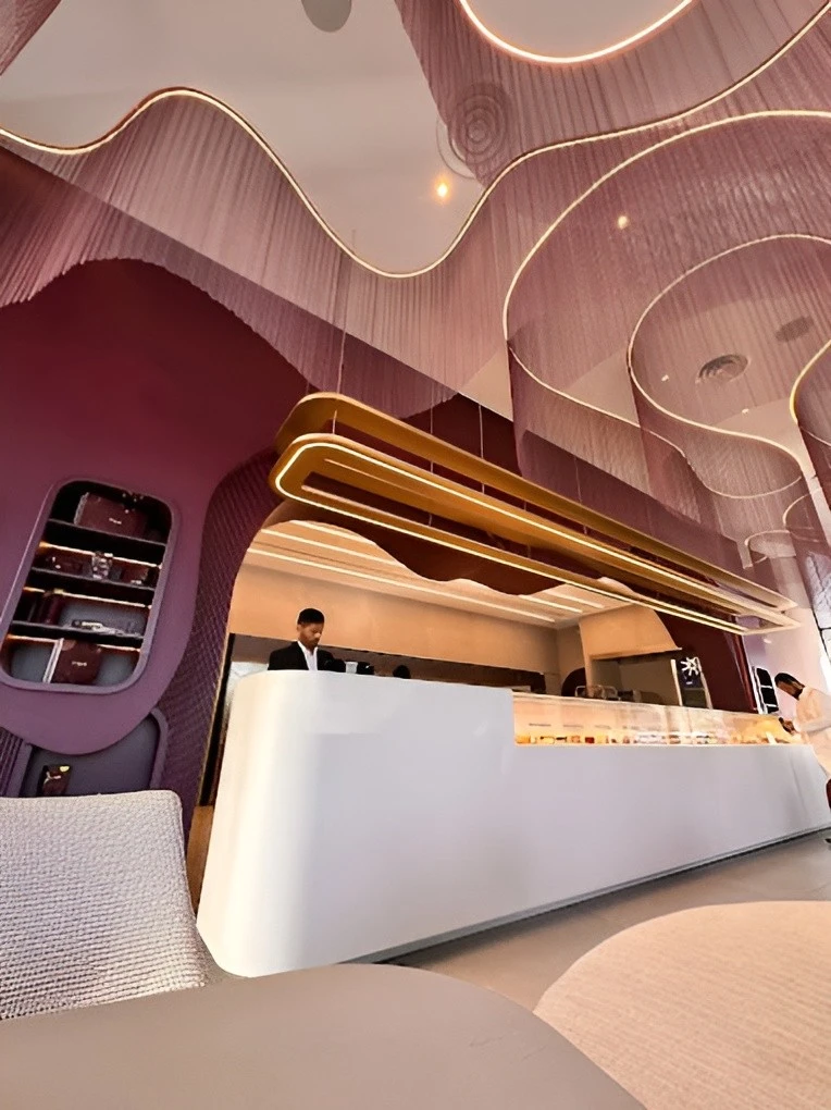 Modern interior of Myra Cafe Jeddah with sleek white counter.
