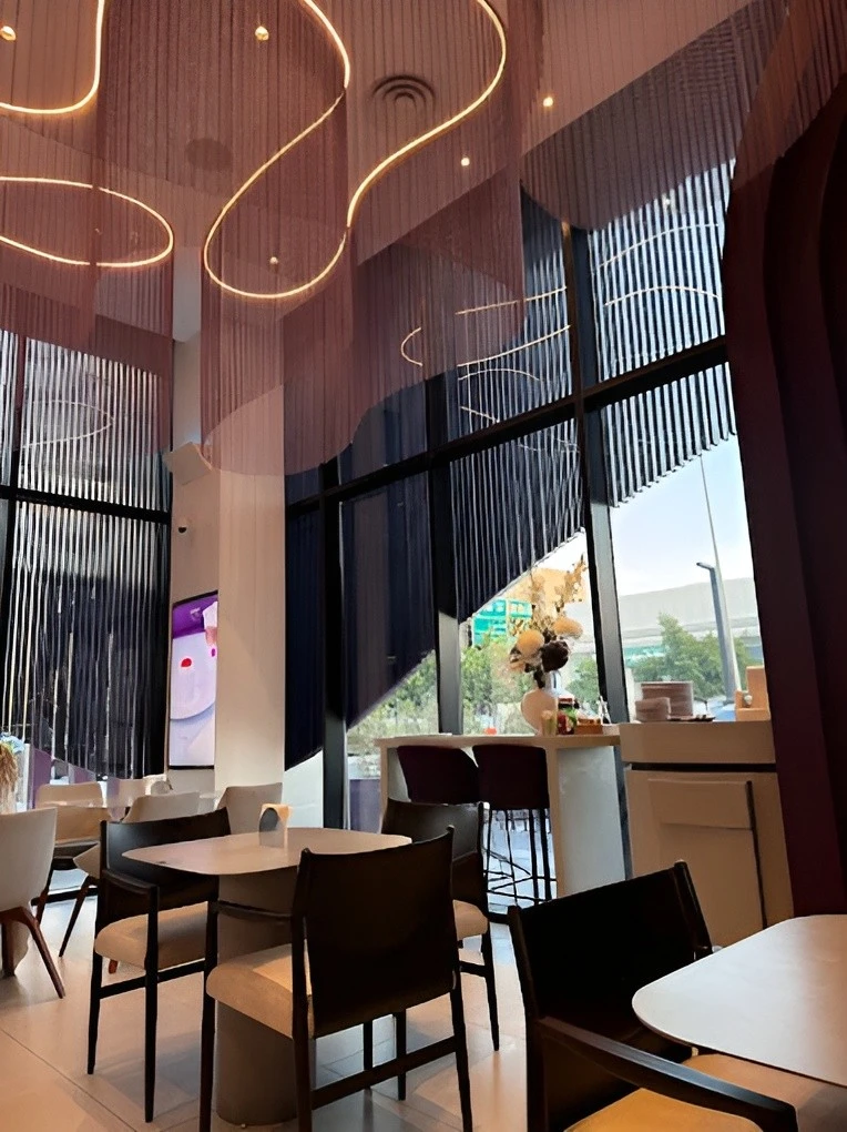 Modern interior of Myra Cafe Jeddah with stylish lighting and seating.