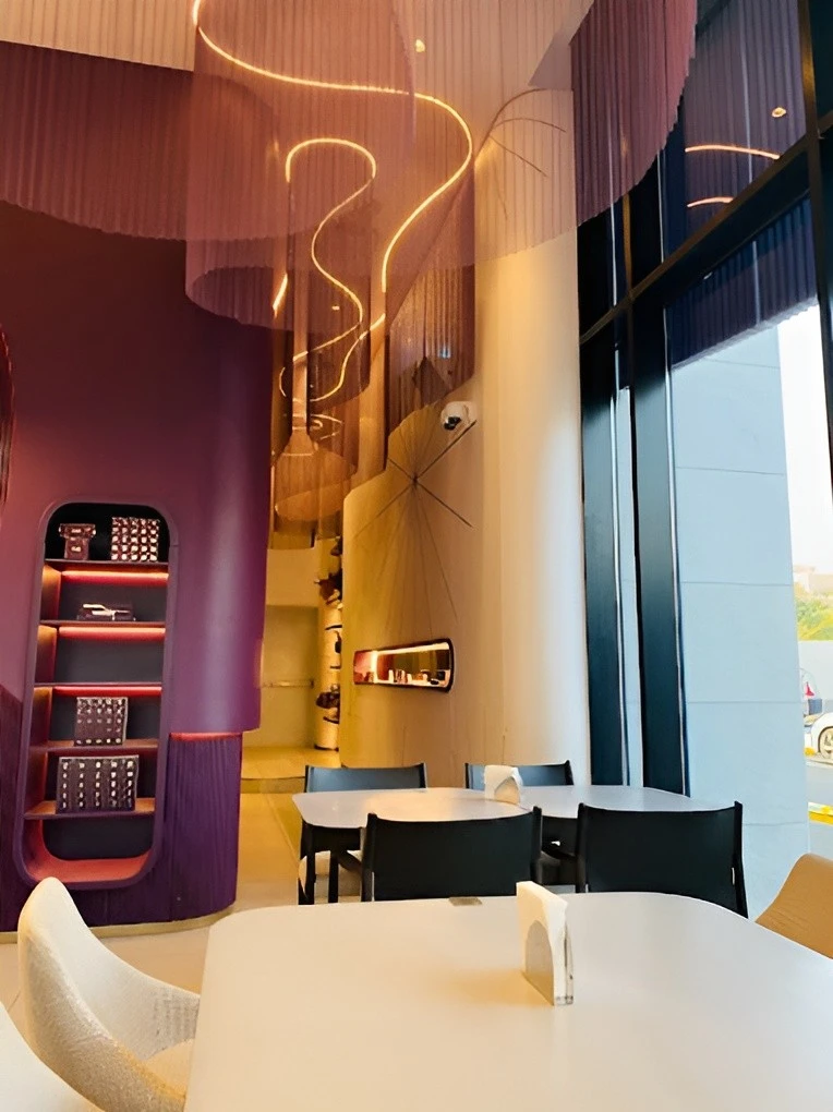 Modern interior of Myra Cafe Jeddah with artistic lighting and seating.