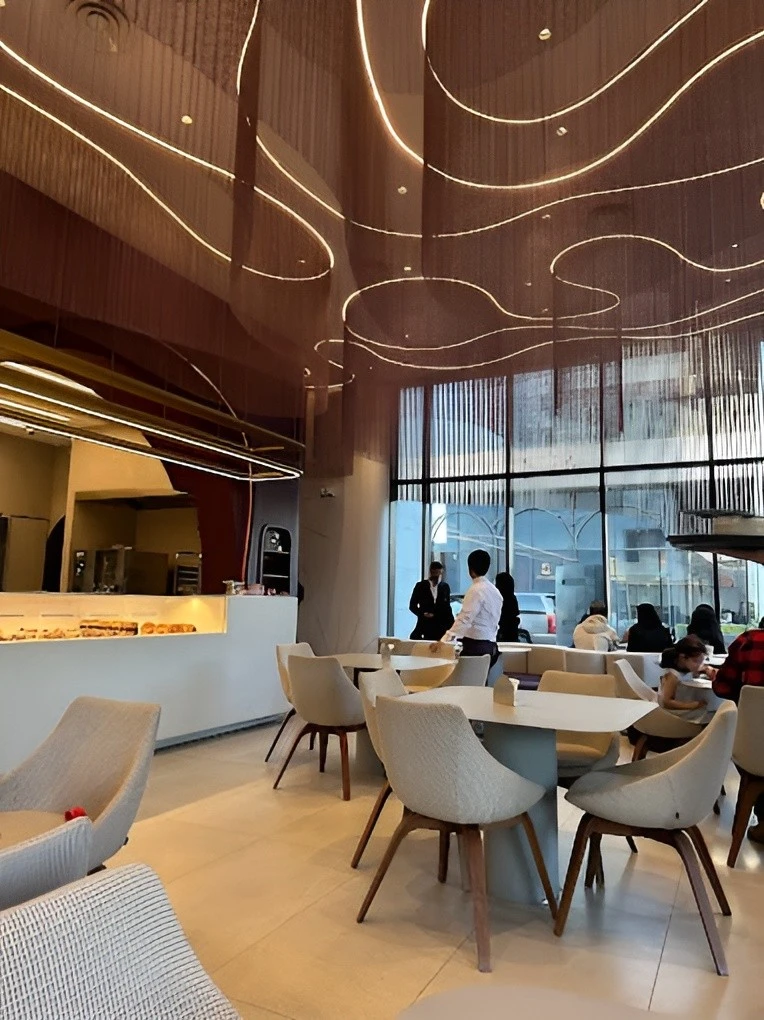 Contemporary Myra Cafe Jeddah interior with elegant ceiling design.