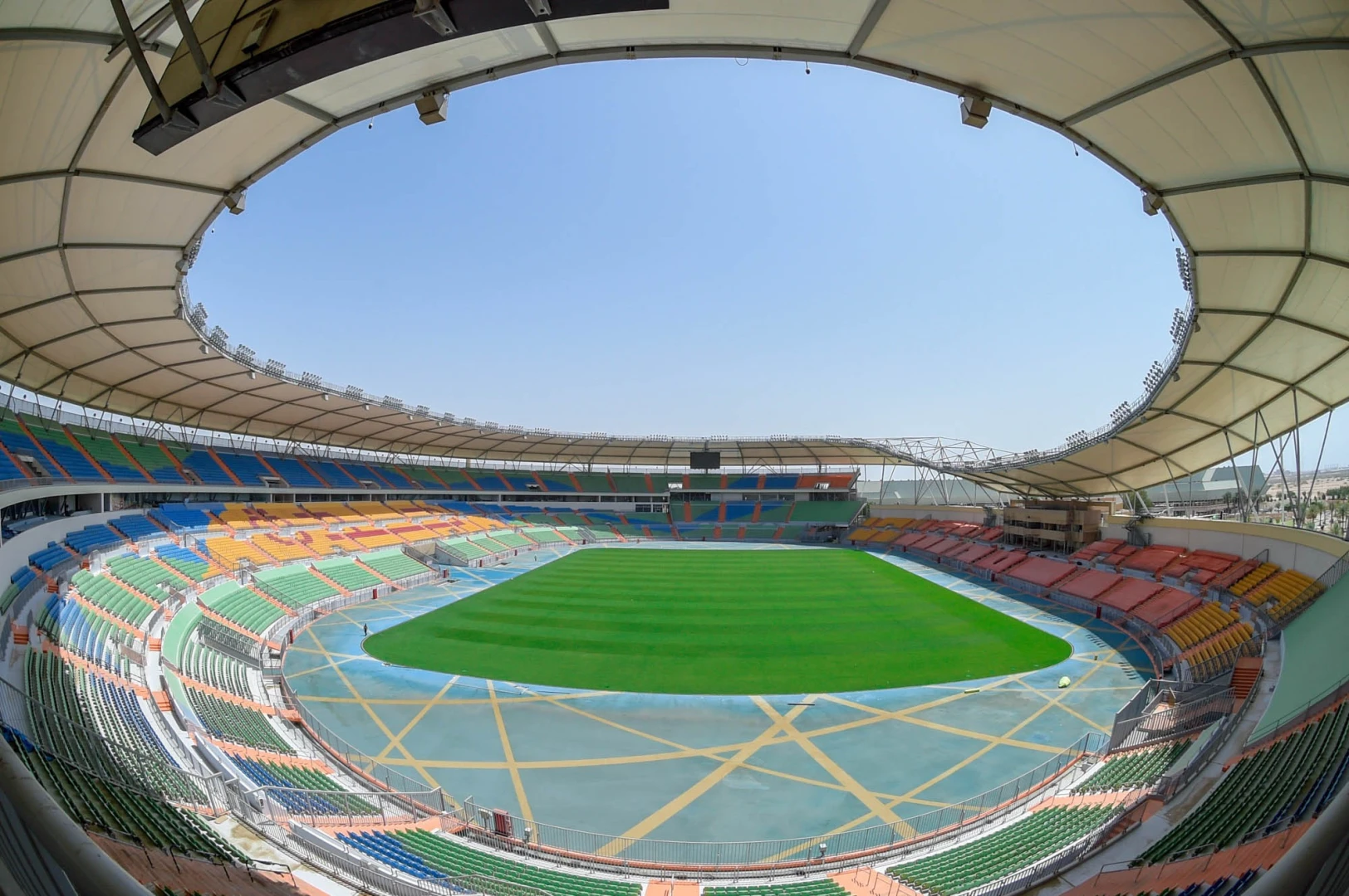 Prince Abdullah Al Faisal Stadium, Jeddah, empty with colorful seating.