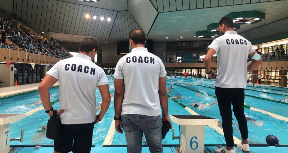 Coaches overlooking swimming pool at Prince Abdullah Al Faisal Sports City, Jeddah.