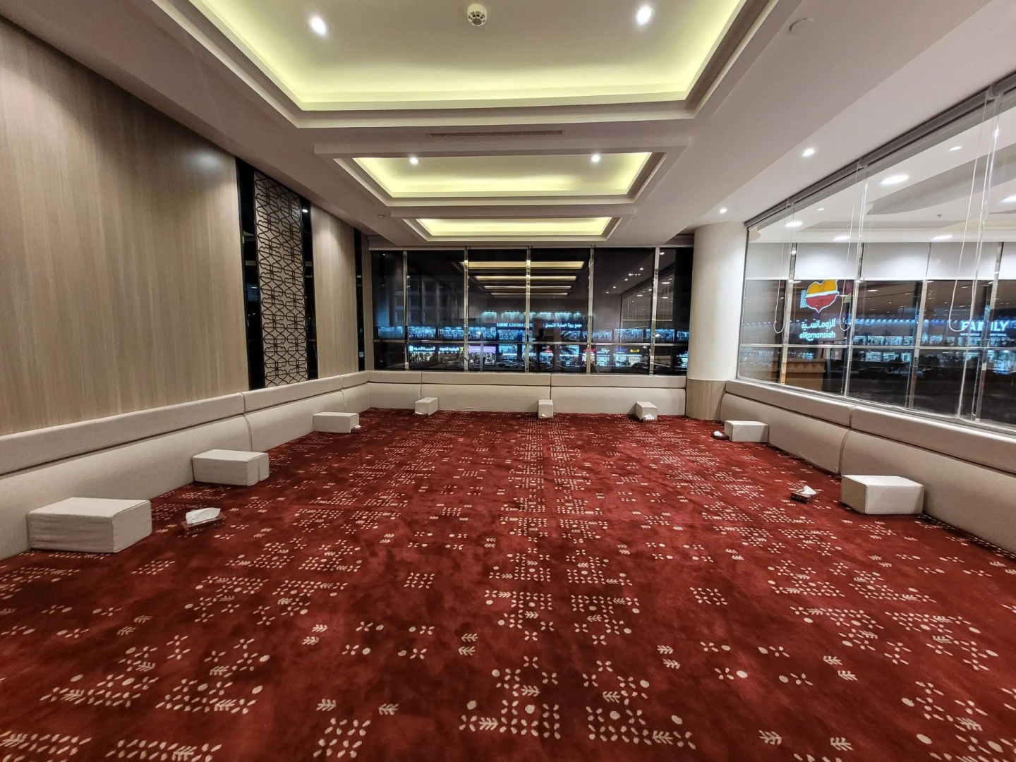 Spacious dining area with red carpet at Al Romansiah Restaurant Makkah.