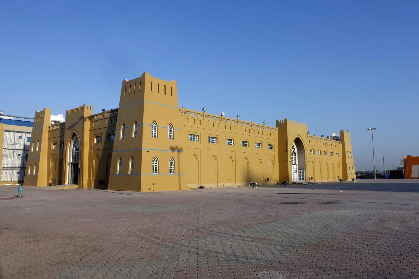 Rak Expo Center in Ras Al-Khaimah, large yellow building exterior.