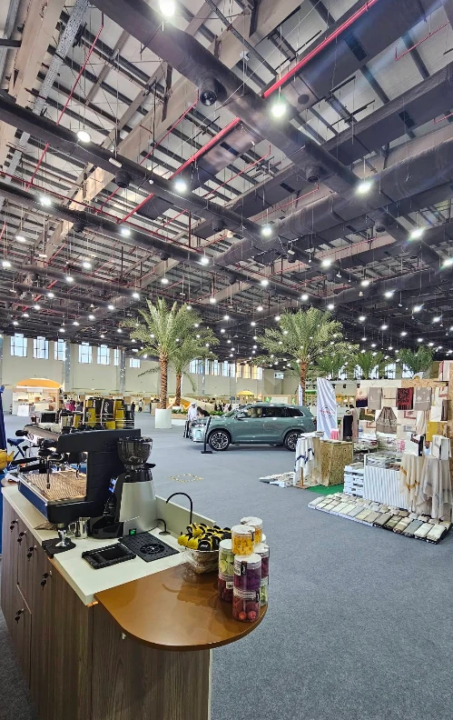Rak Expo Center interior with displays and palm trees, Ras Al-Khaimah.