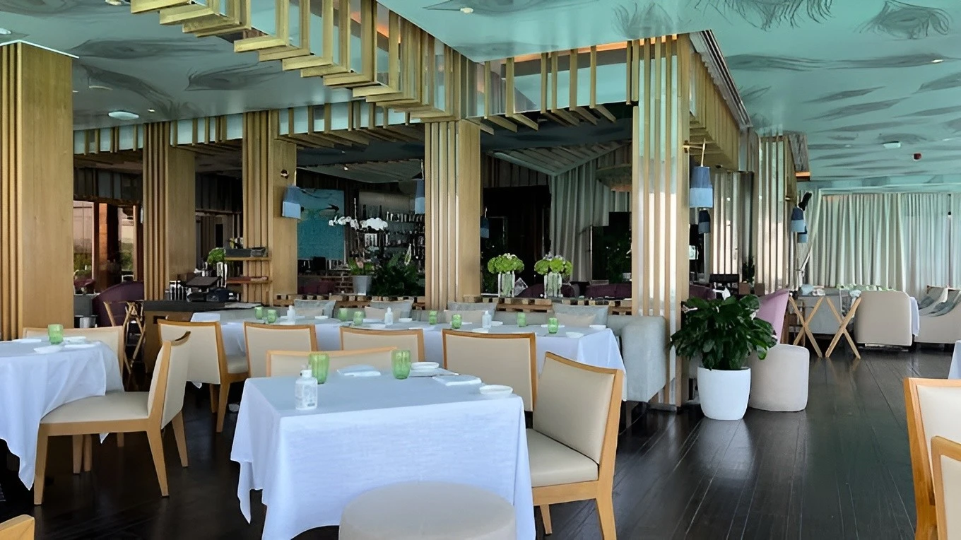 Elegant dining area at Pierchic Restaurant, Dubai with wooden decor.