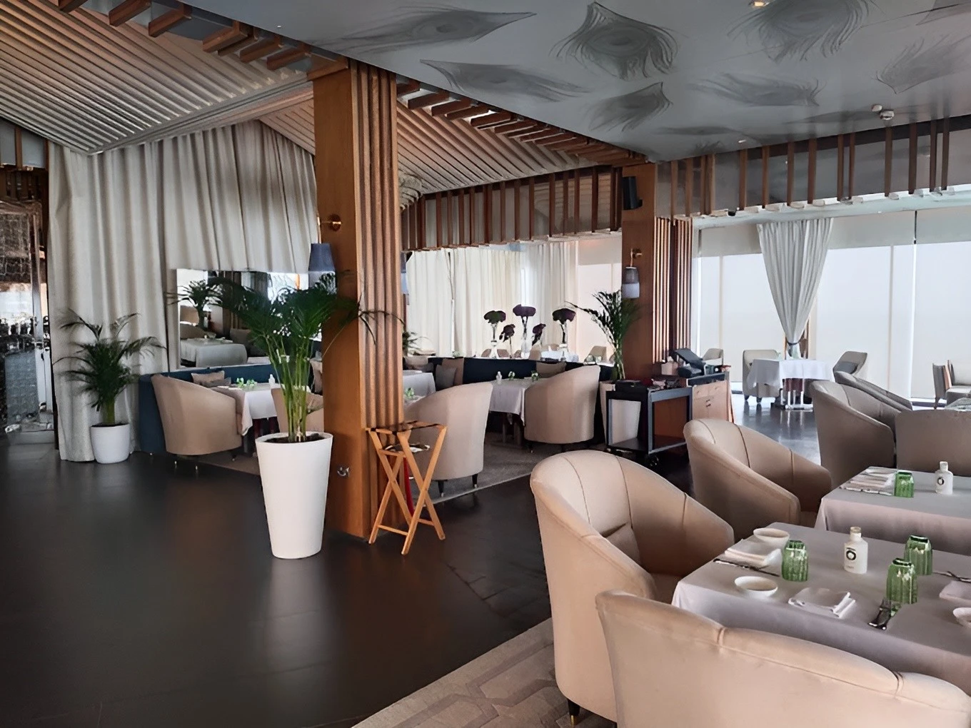 Elegant dining area at Pierchic Restaurant, Dubai with modern decor.