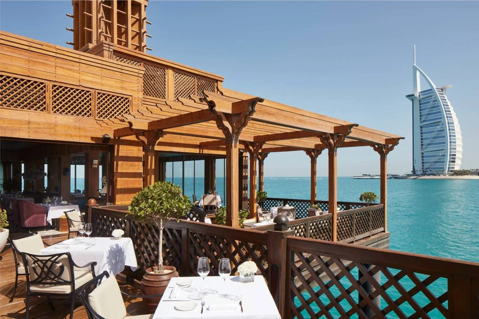Pierchic Restaurant Dubai terrace overlooking ocean and iconic building.