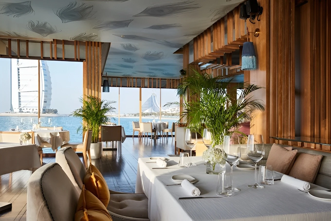 Elegant dining area at Pierchic Restaurant, Dubai with sea view.