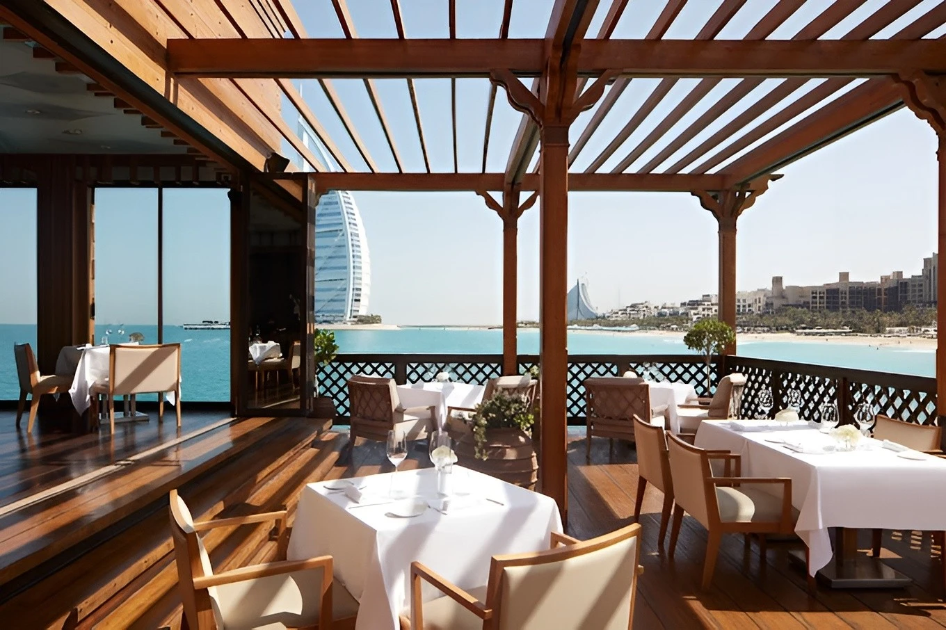 Pierchic Restaurant Dubai, outdoor dining with sea and skyline views.