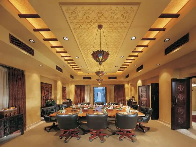 Elegant dining room at Bab Al Shams, Dubai, with ornate ceiling.