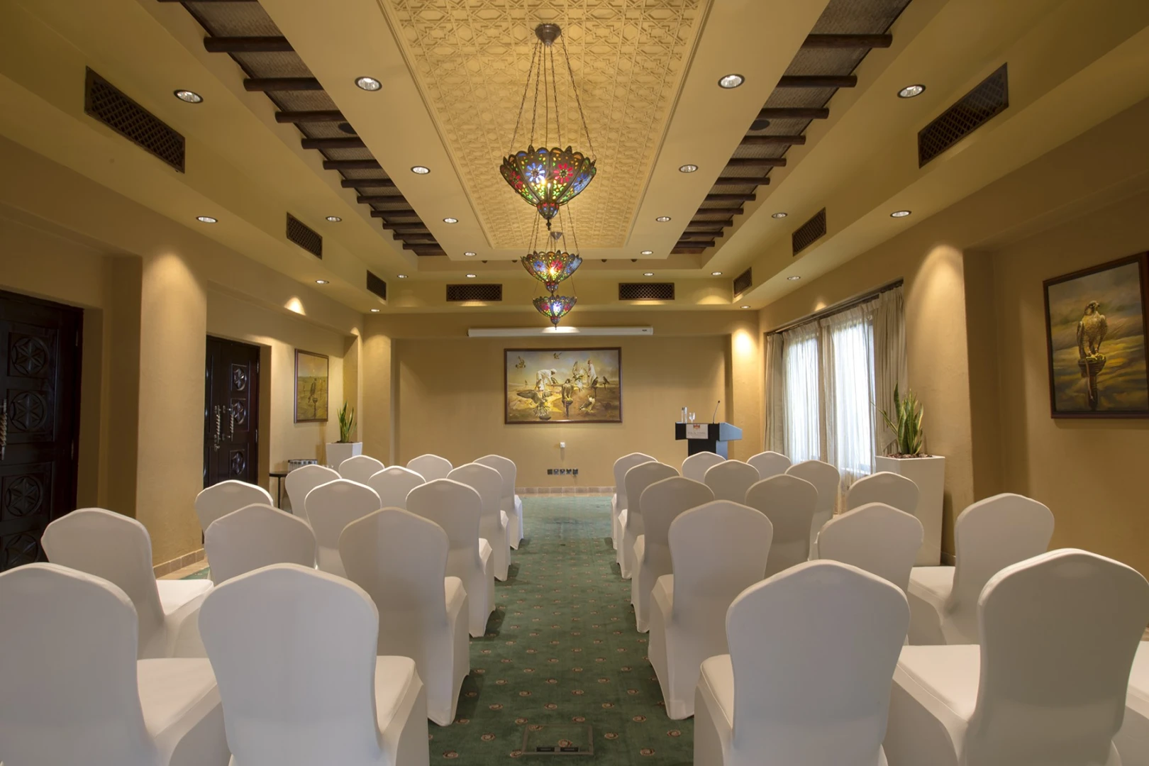 Conference room at Bab Al Shams, Dubai, with elegant chandeliers.