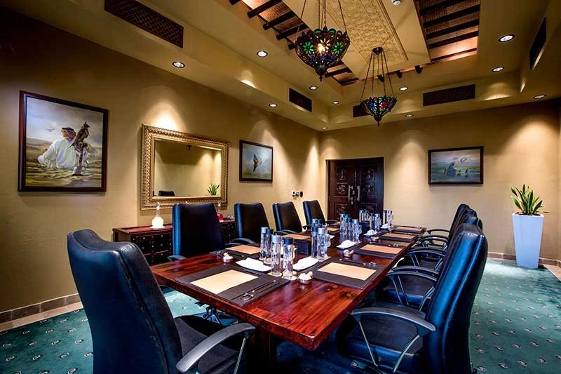 Elegant meeting room at Bab Al Shams, Dubai, with leather chairs.