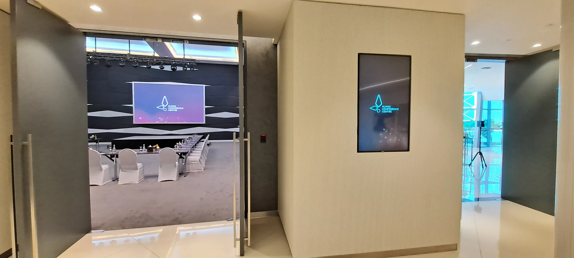 Entrance to Almas Conference Centre, Dubai, with modern interior design.