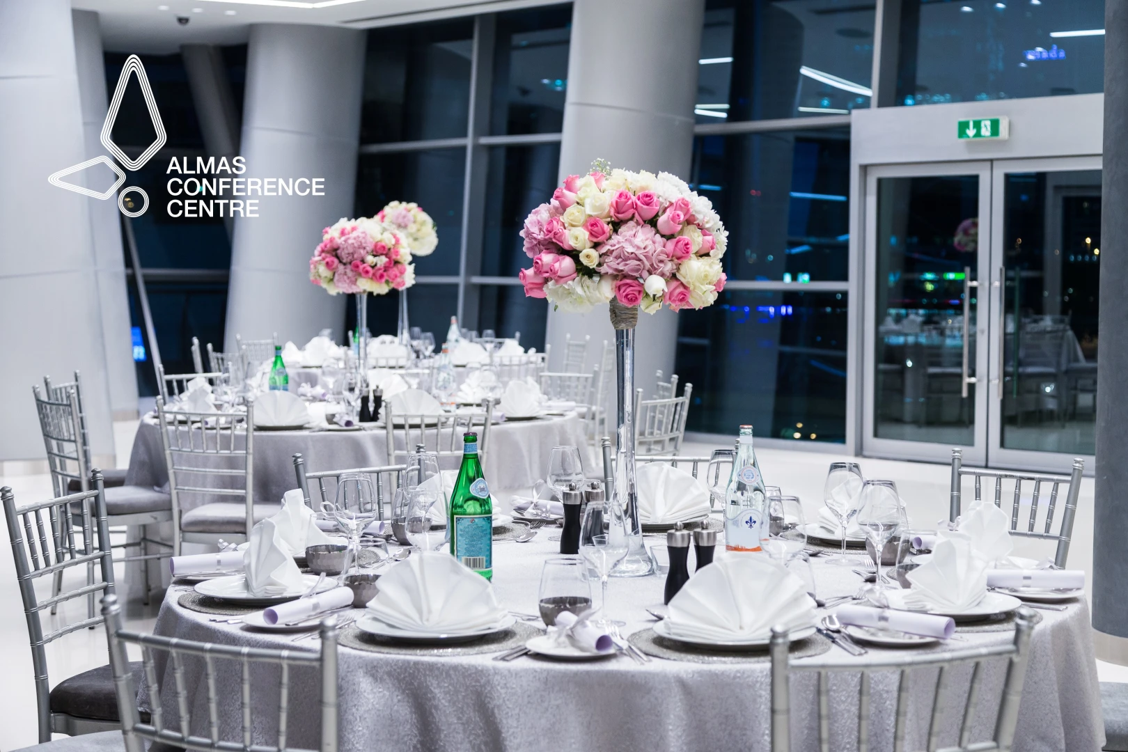 Sophisticated table arrangement with floral centerpieces at Almas Conference Centre, Dubai.