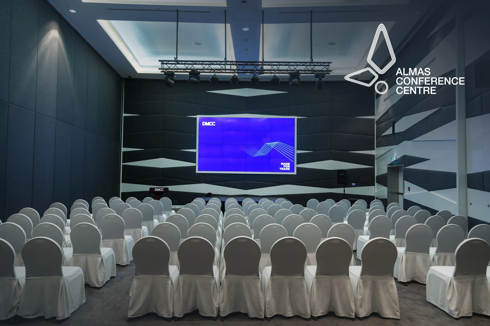 Almas Conference Centre auditorium with rows of white chairs, Dubai.