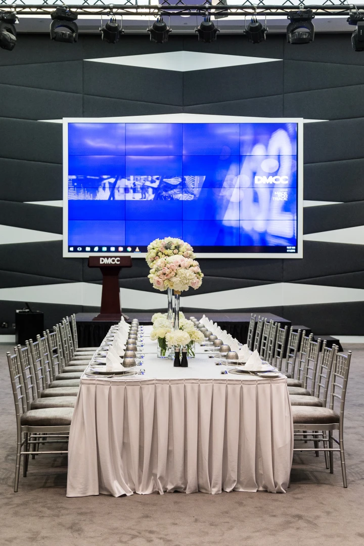 Formal dining setup with floral centerpiece, Almas Conference Centre, Dubai.