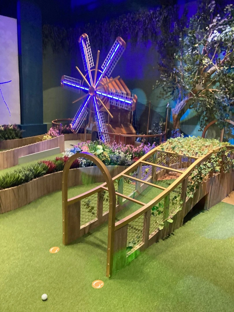 Mini-golf course with windmill at Swingers The Crazy Golf Club Dubai.