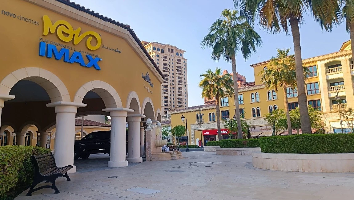 Novo Cinemas The Pearl Doha entrance with palm trees and arches.