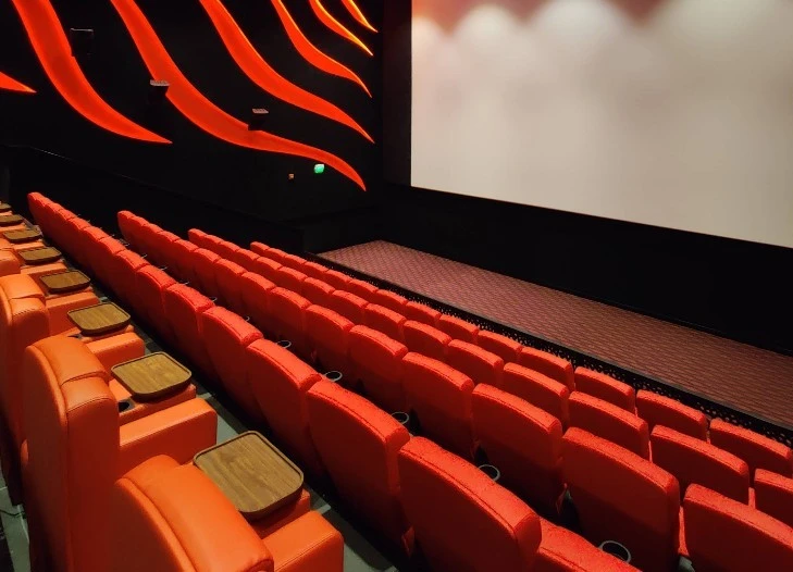 Novo Cinemas Msheireb Doha, red seats, large screen, modern interior design.