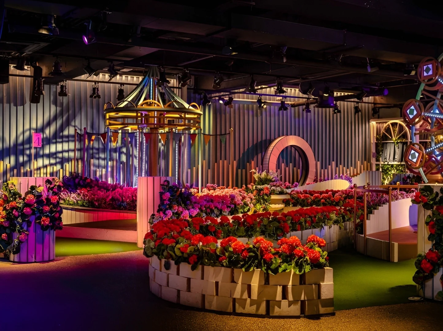 Colorful mini-golf course with flowers at Swingers The Crazy Golf Club Dubai.