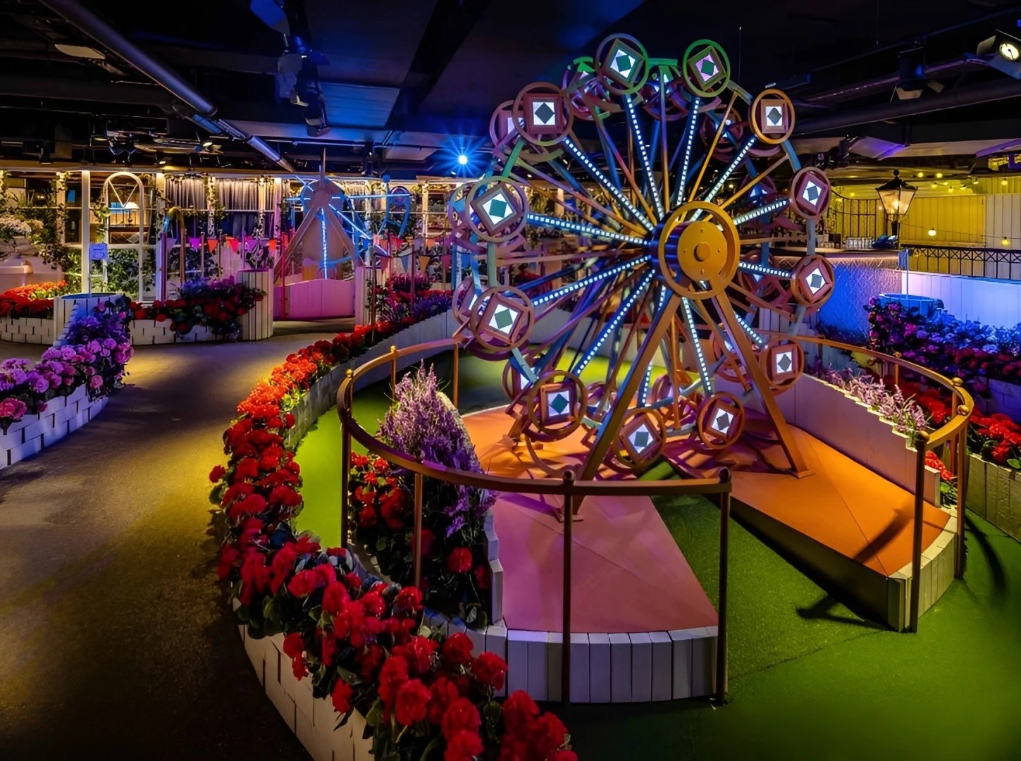 Colorful mini golf course with Ferris wheel at Swingers Dubai.