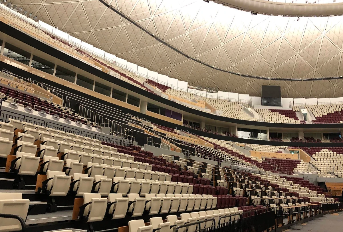 Interior of Lusail Multipurpose Hall, Doha, with empty tiered seating.
