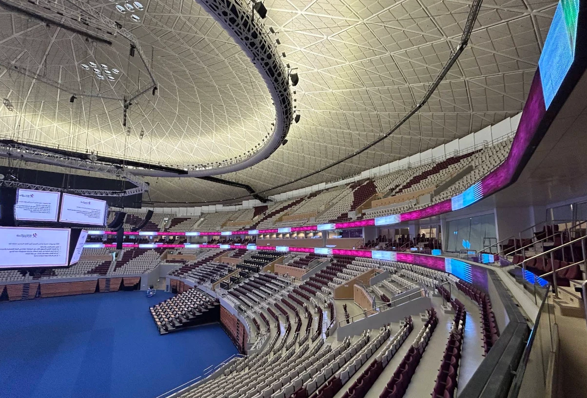 Interior of Lusail Multipurpose Hall, Doha, with seating and screens.