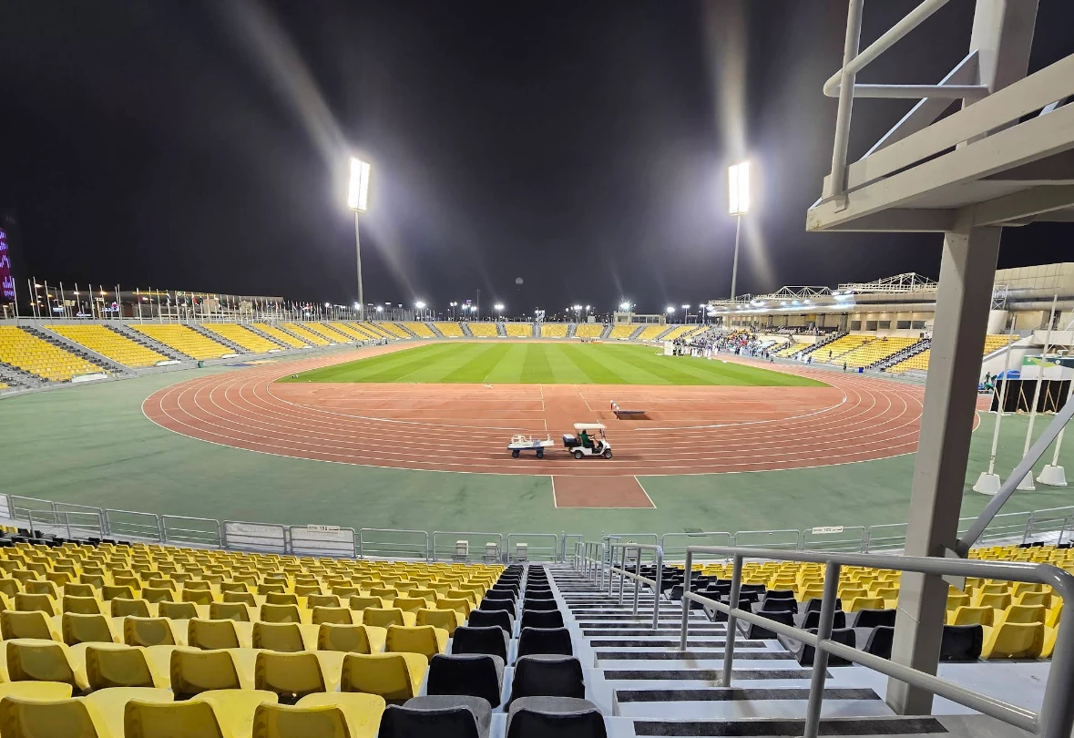 Suheim Bin Hamad Stadium in Doha, illuminated at night.