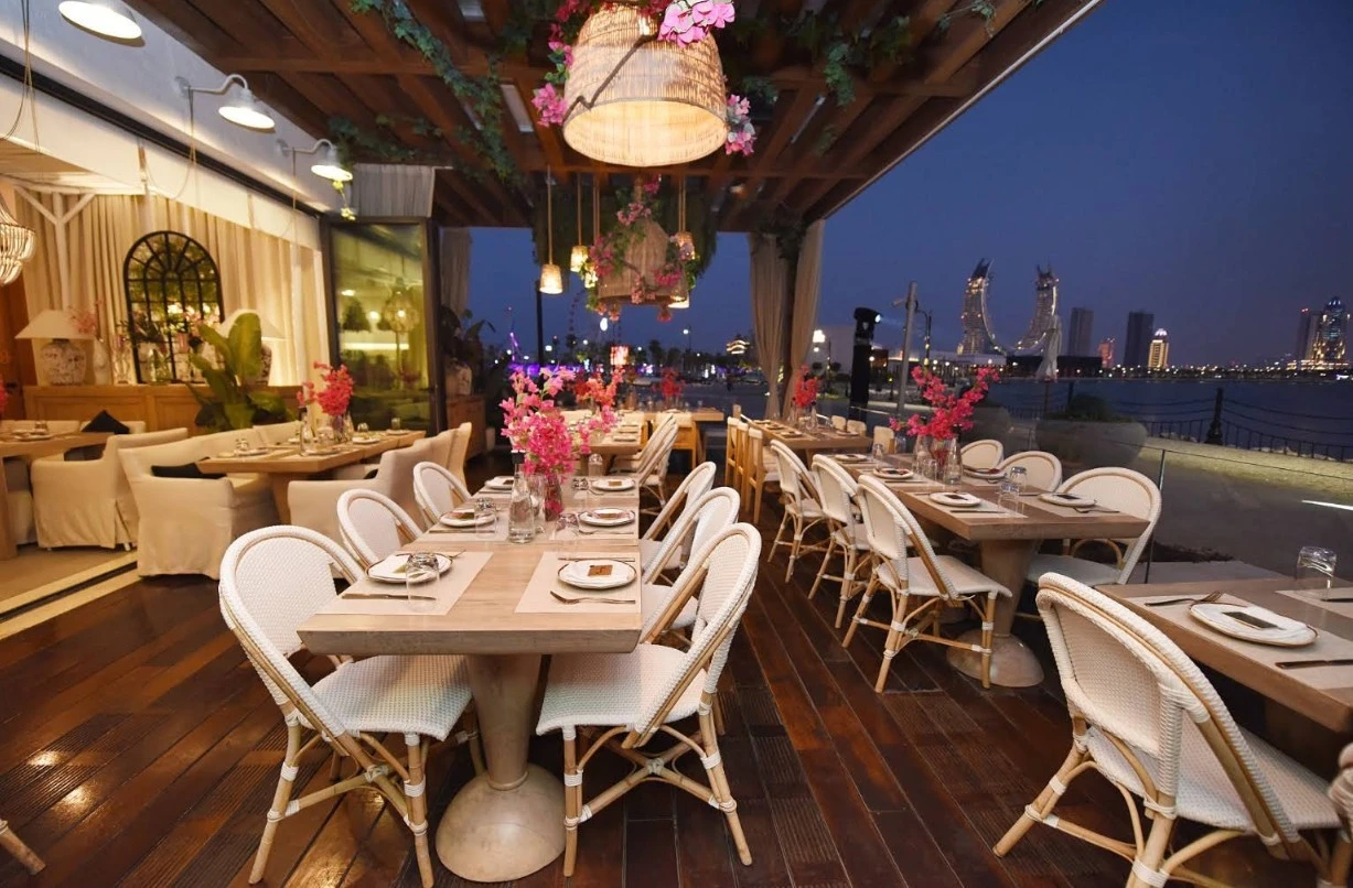 Elegant dining setup at Viva La Vida Doha, Lusail waterfront view.
