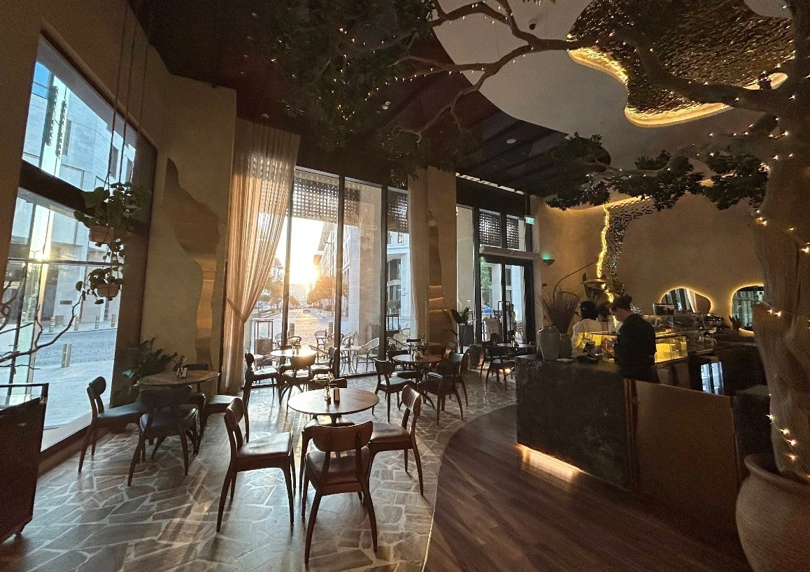 Cozy interior of Era Restaurant Doha at sunset.