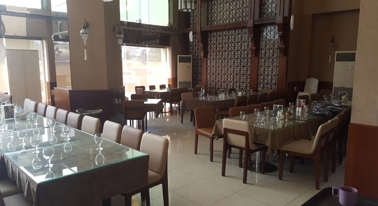 Spacious dining setup with glass tables at Nayaab Haandi, Dubai.