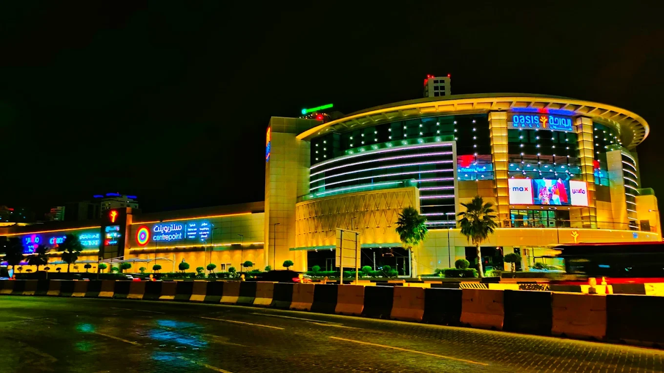 Oasis Mall Cinema Juffair illuminated at night, Manama.