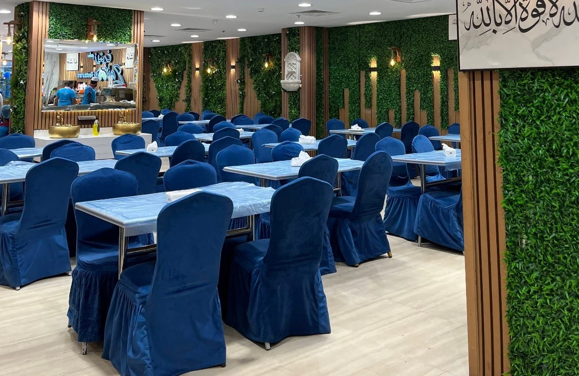 Zaitoon Restaurant Madinah dining area with lush green decor.